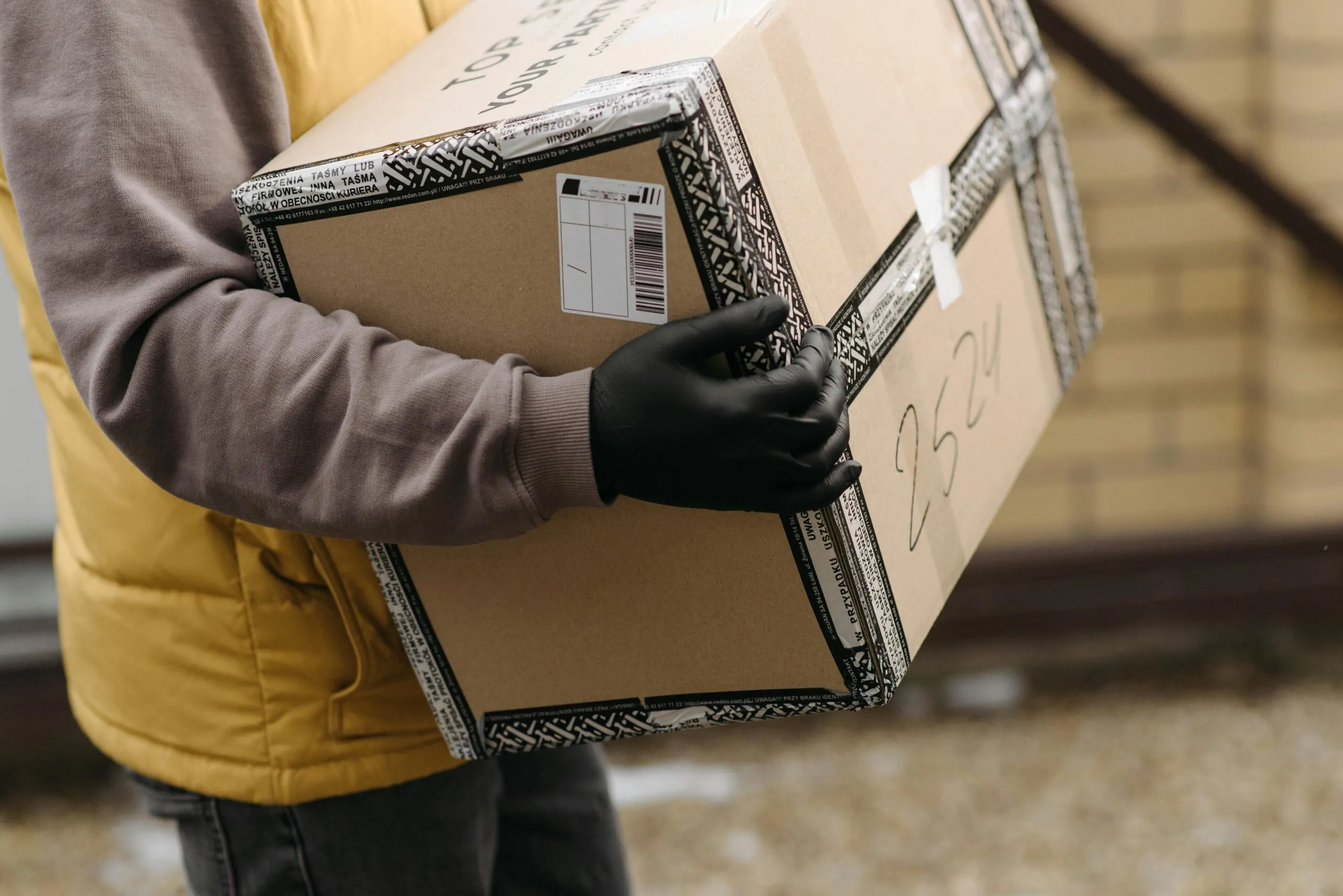Courier handing over a parcel at a front door