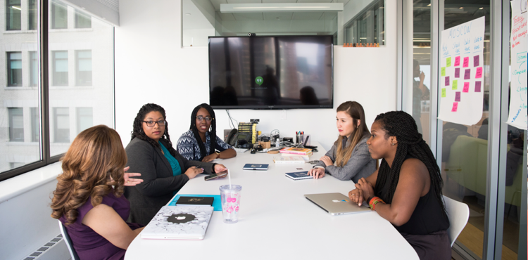 Group of professionals in a meeting room discussing strategies, representing collaboration and planning for leveraging automated repricing for competitive advantage