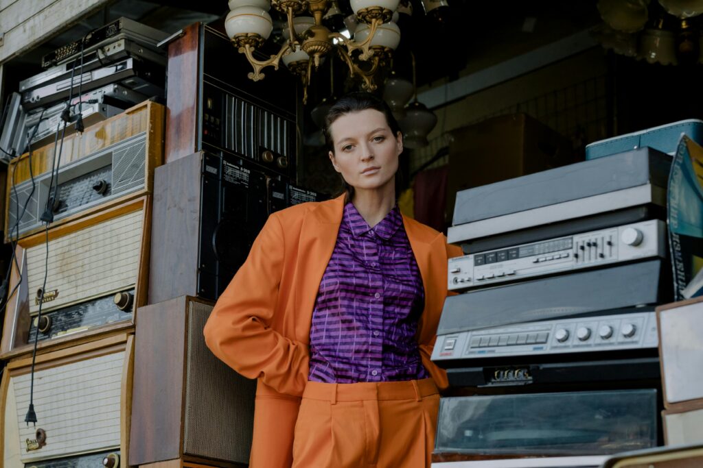 A woman standing amidst all the products to be used in ebay flipping
